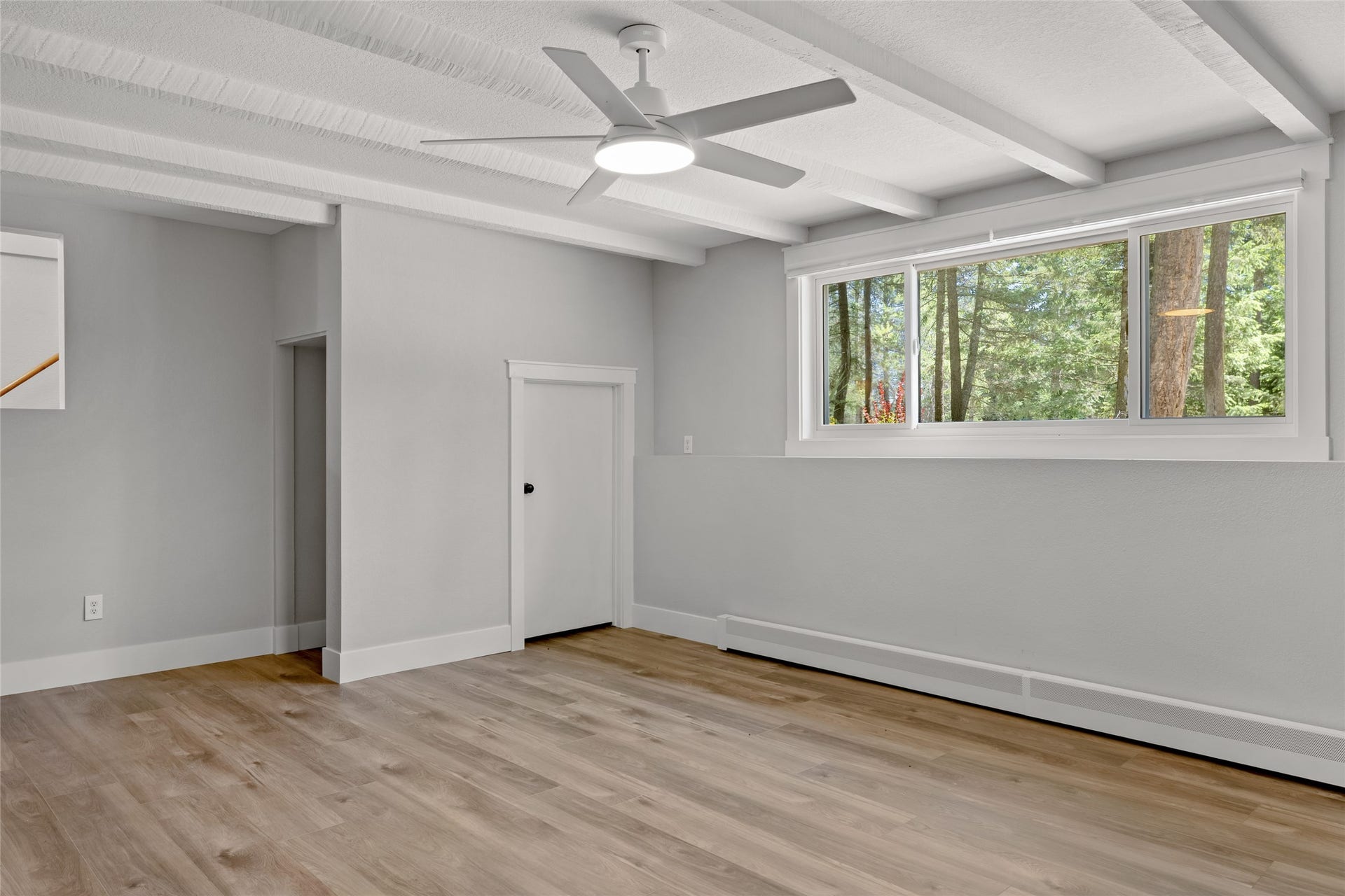 112 Mallard Loop, Whitefish, MT 59937 Family Room looking N. Beamed ceiling, huge window, ceiling fan. Direct access to garage.