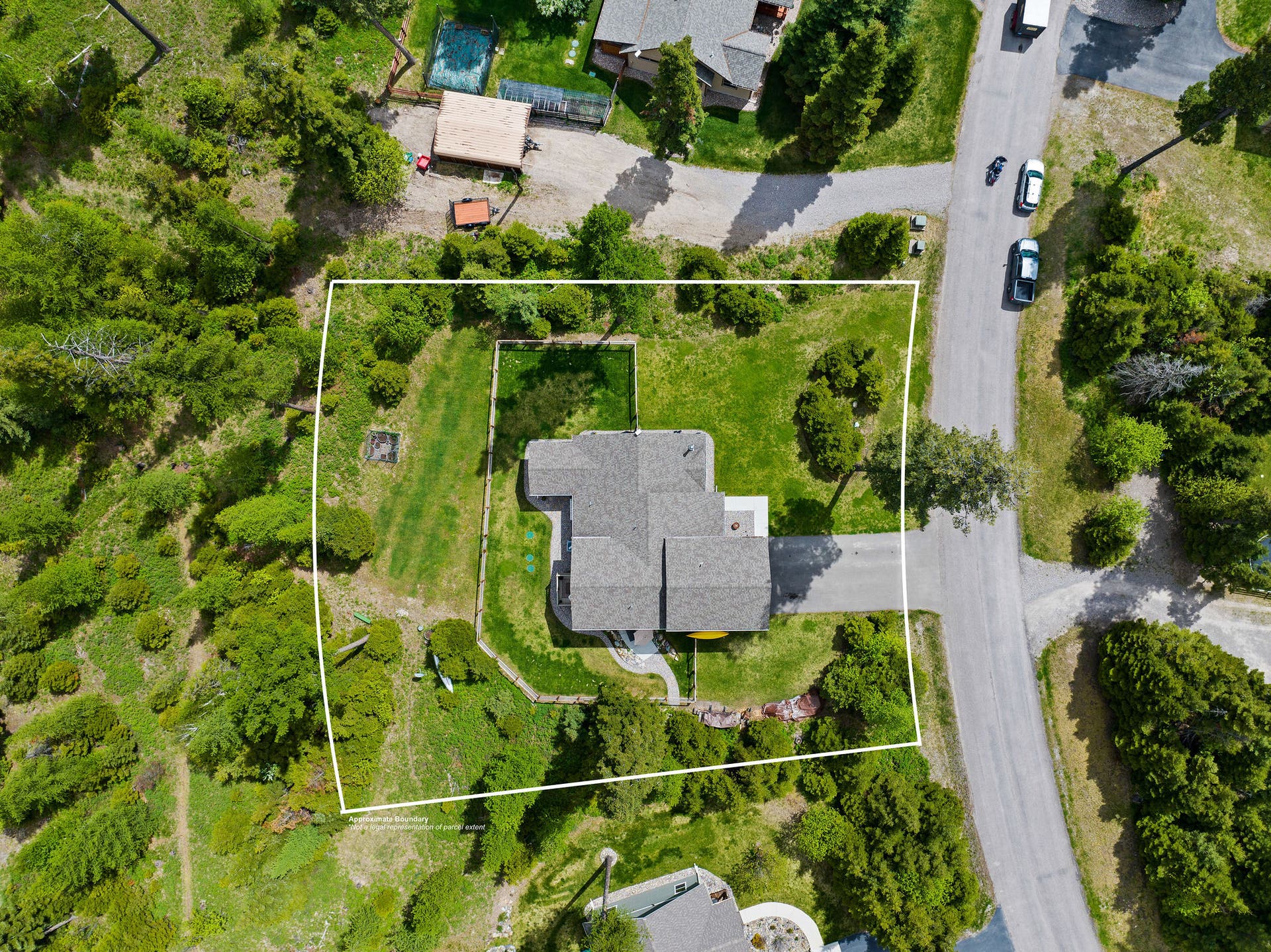 13404 Crescent Moon Drive, Bigfork, MT 59911 Overhead drone view displaying the approximate property lines of the 0.63-acre lot