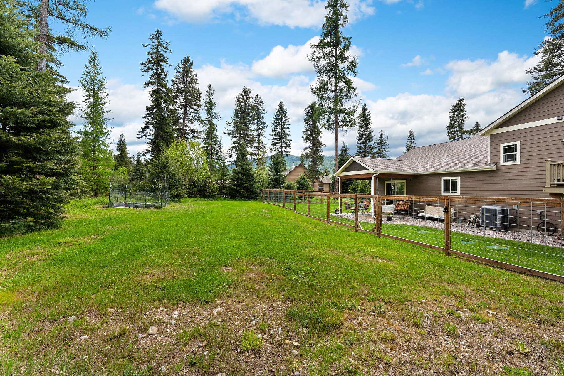13404 Crescent Moon Drive, Bigfork, MT 59911 Large, open backyard space surrounded by mature trees for ultimate privacy