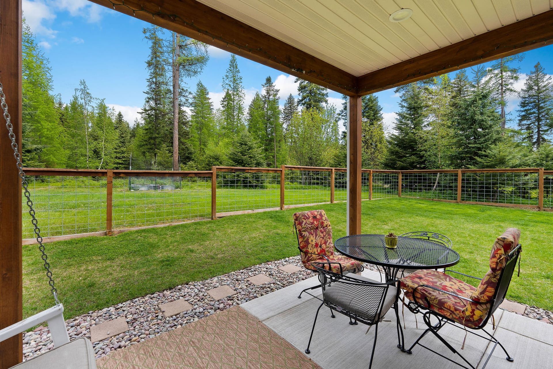 13404 Crescent Moon Drive, Bigfork, MT 59911 Scenic back patio view looking out over the private, peaceful backyard