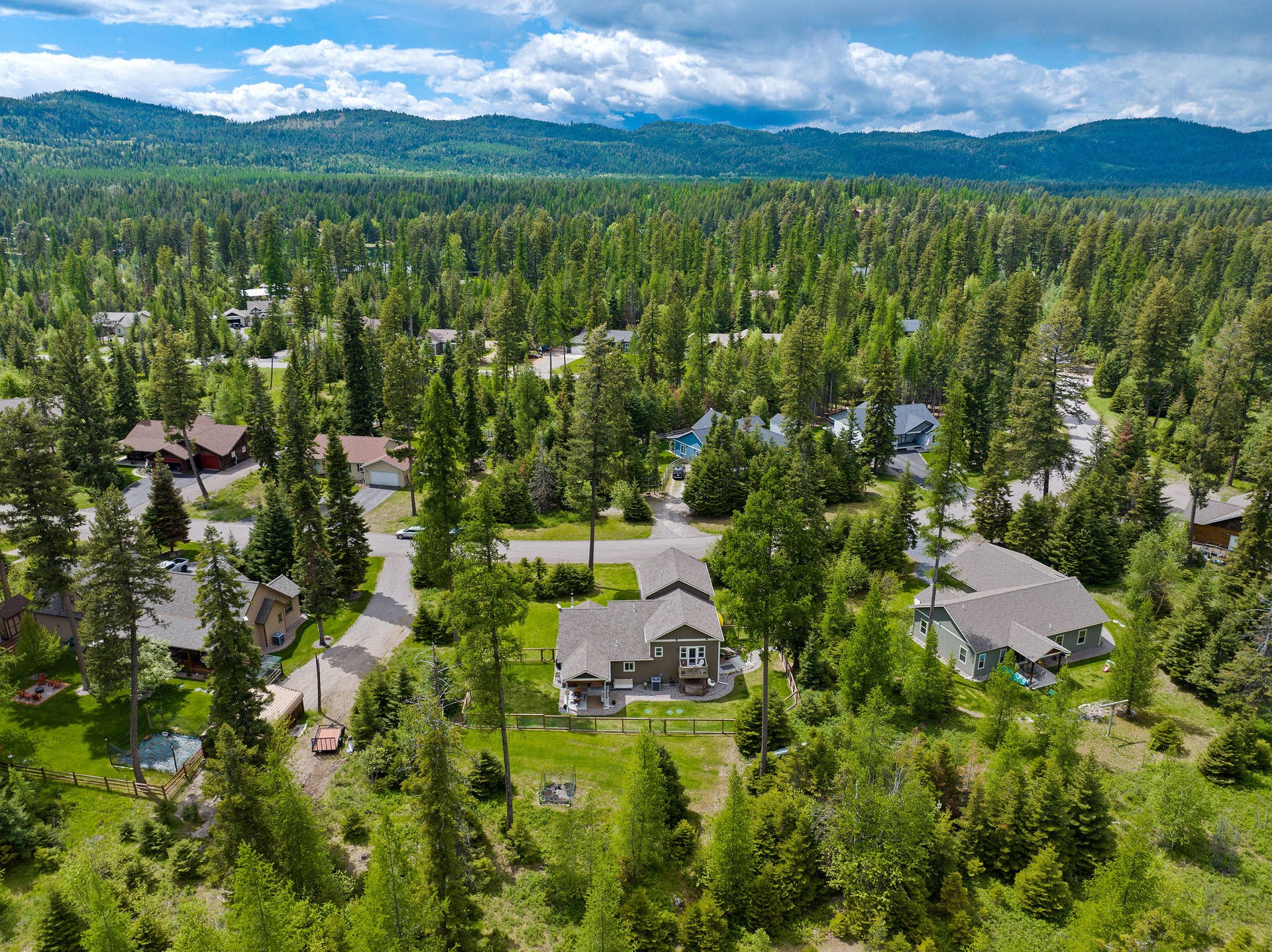 13404 Crescent Moon Drive, Bigfork, MT 59911 Elevated view of the peaceful, tree-lined neighborhood setting