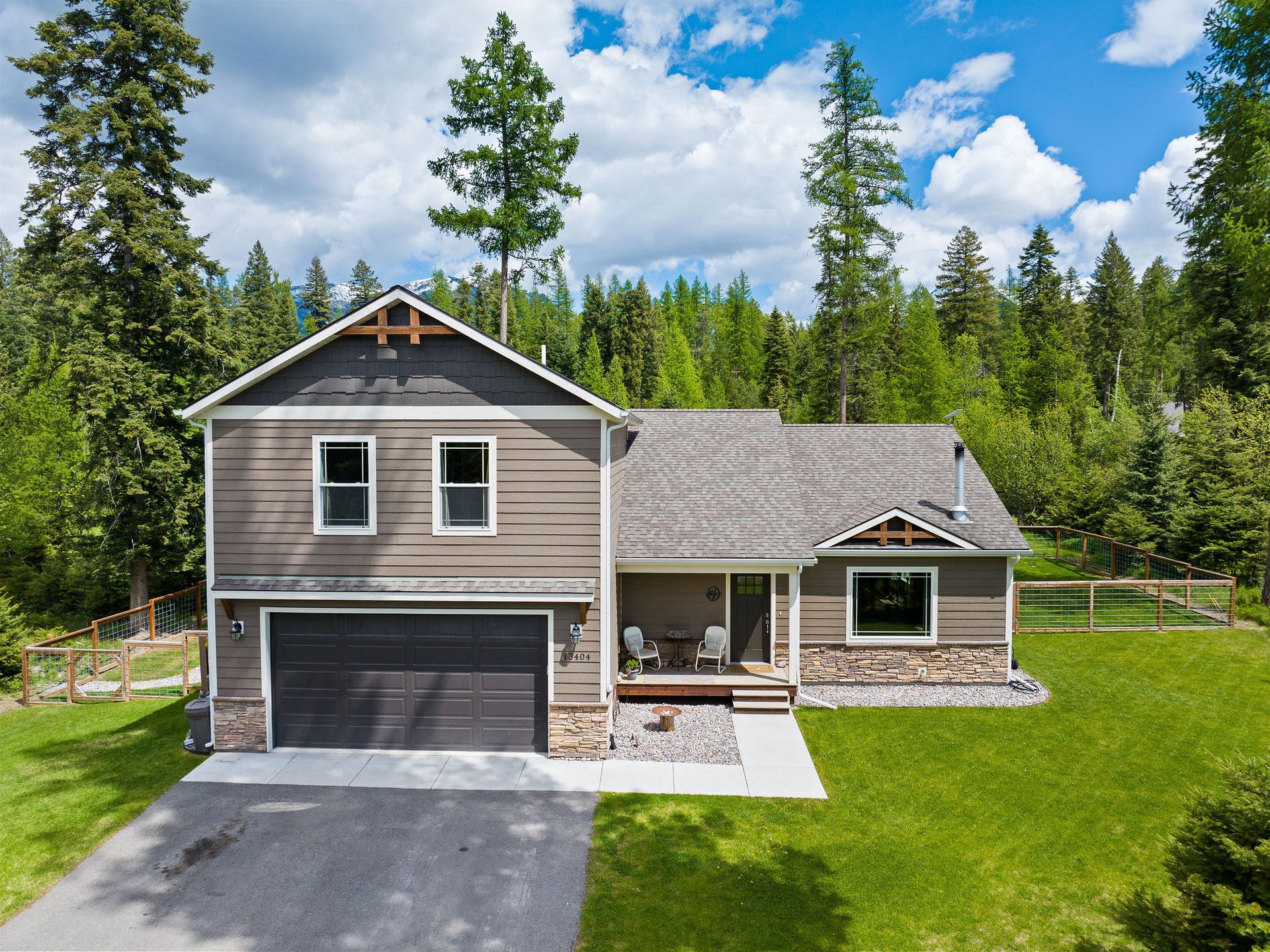 13404 Crescent Moon Drive, Bigfork, MT 59911 Beautifully maintained front exterior with an attached two-car garage