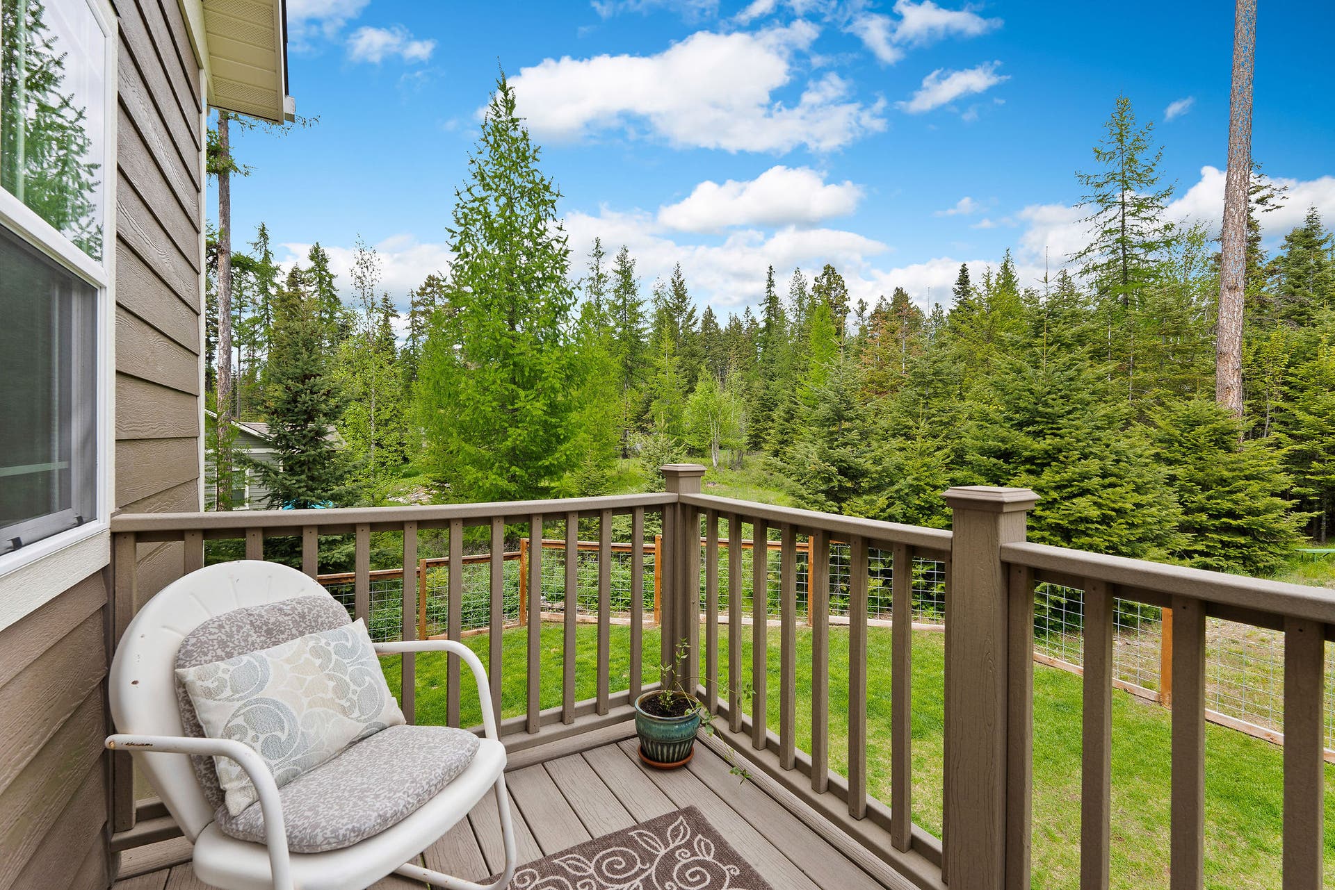 13404 Crescent Moon Drive, Bigfork, MT 59911 Private primary suite balcony looking out over the wooded yard