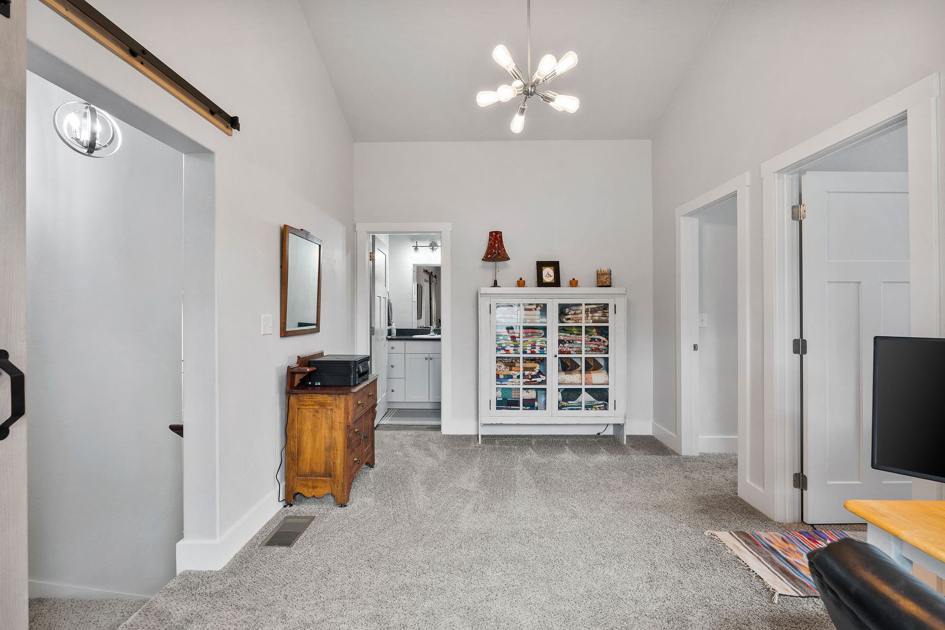 13404 Crescent Moon Drive, Bigfork, MT 59911 Open loft landing featuring a stylish rustic sliding barn door