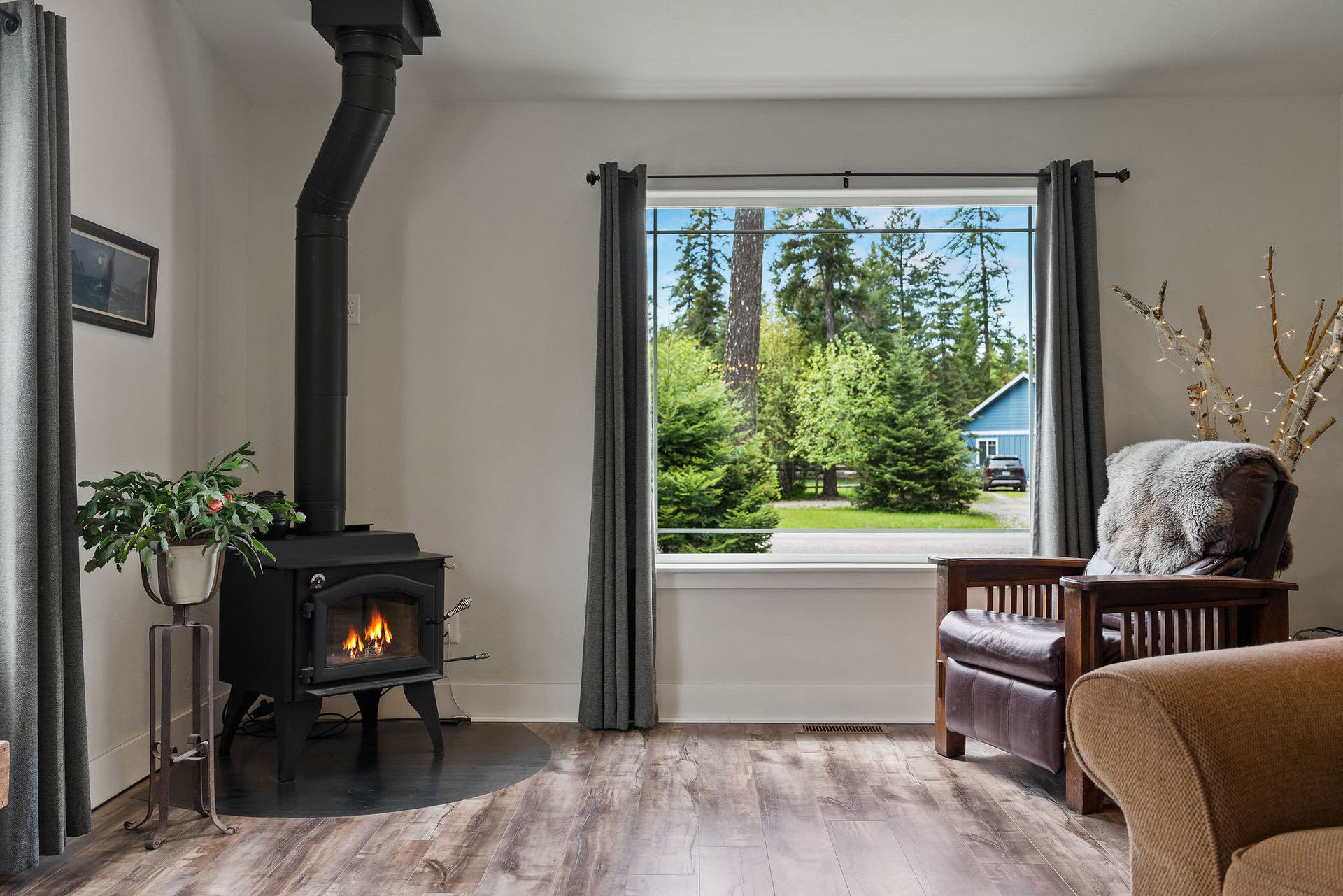 13404 Crescent Moon Drive, Bigfork, MT 59911 Cozy corner featuring a warm wood stove and large picture window