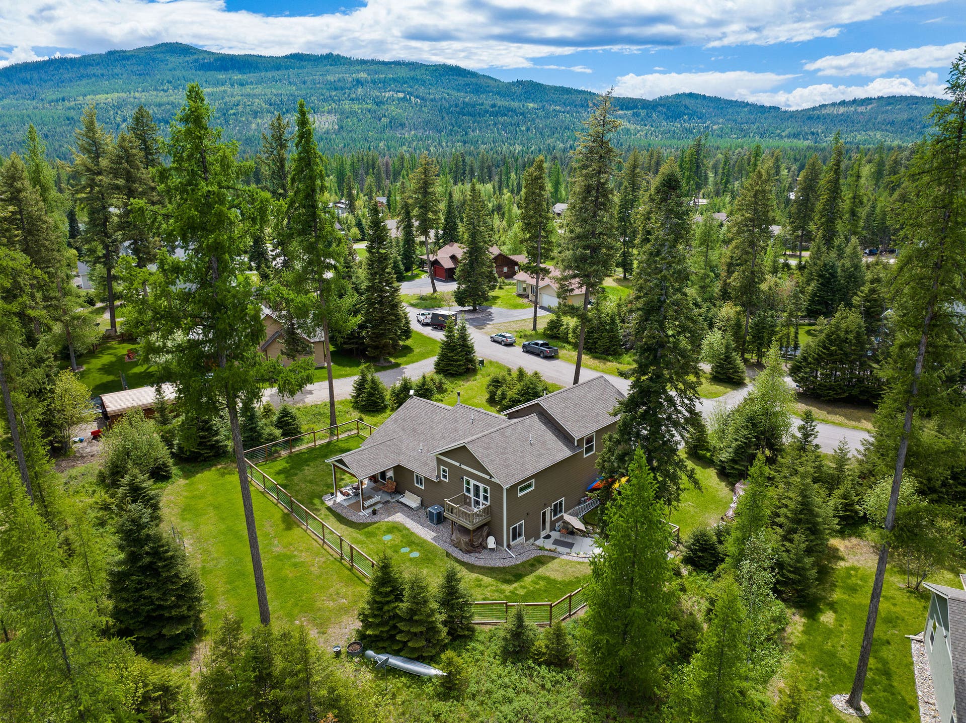 13404 Crescent Moon Drive, Bigfork, MT 59911 Scenic aerial overview of the home and its private, wooded acreage