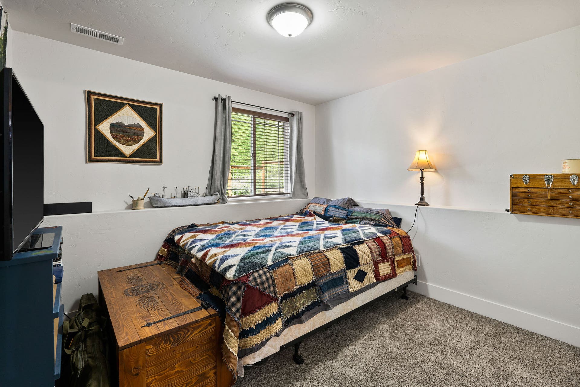 13404 Crescent Moon Drive, Bigfork, MT 59911 Comfortable lower-level bedroom with a large window bringing in natural light