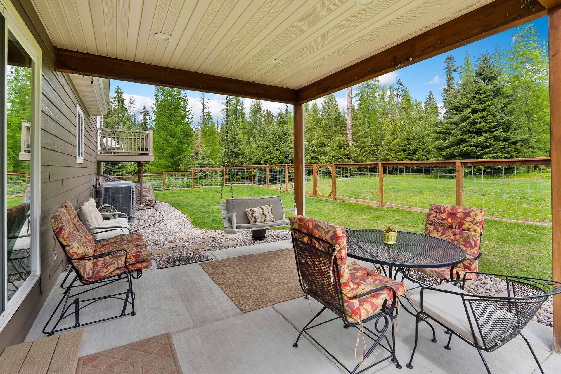 13404 Crescent Moon Drive, Bigfork, MT 59911 Comfortable covered back patio ideal for outdoor dining and relaxing