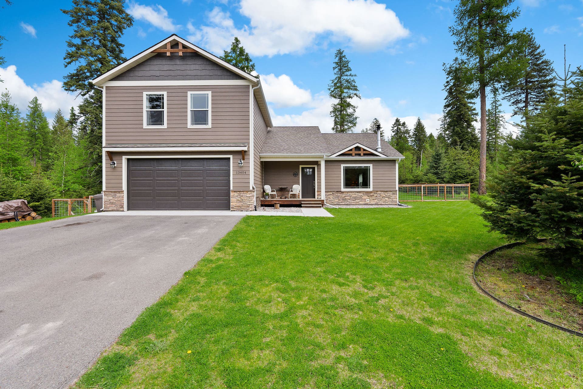 13404 Crescent Moon Drive, Bigfork, MT 59911 Paved driveway with ample parking space leading up to the home