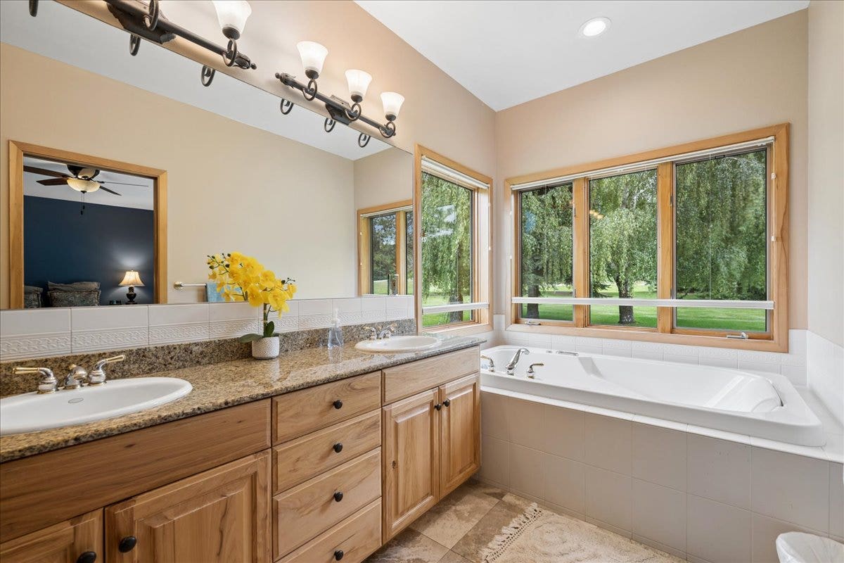 Master bathroom with dual sinks and jetted tub