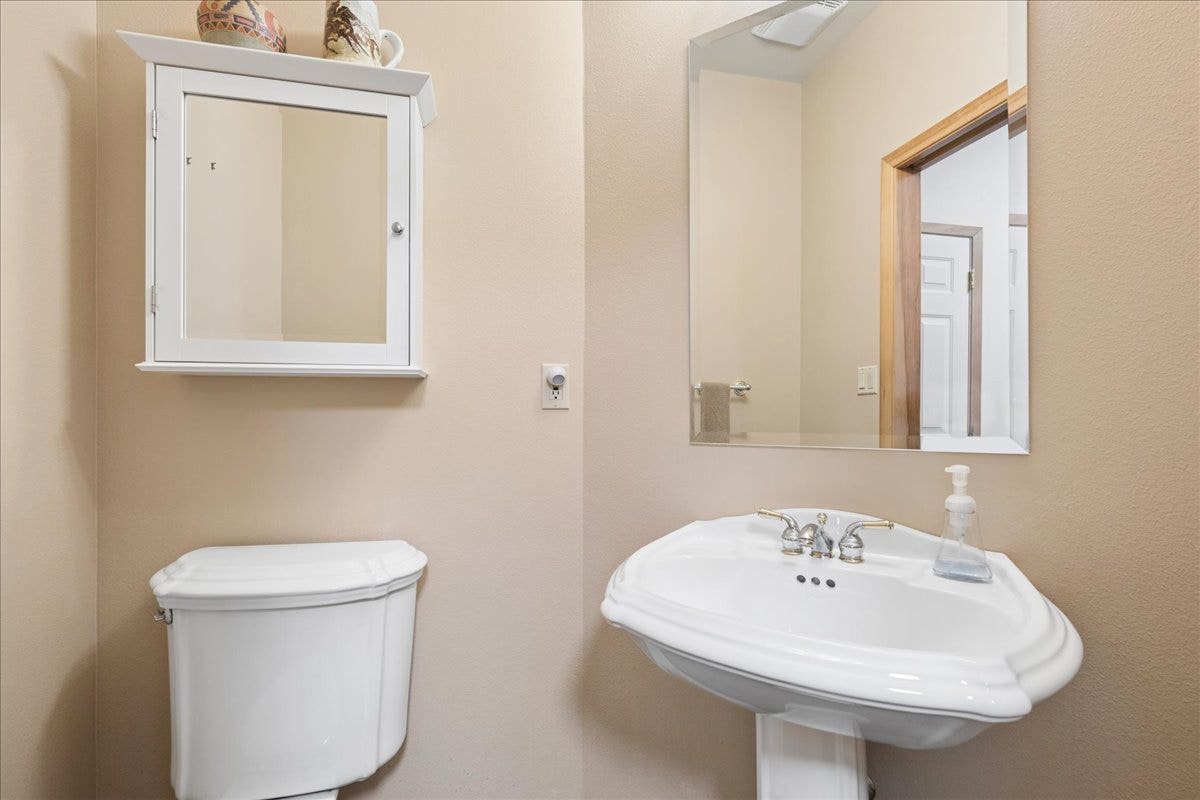 Half bath off of laundry room is perfect for guests.
