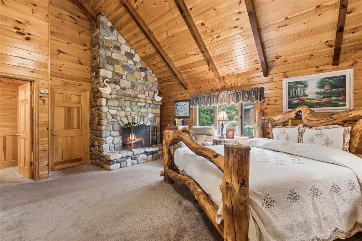 14529 Sunburst Drive, Bigfork, MT 59911 Primary suite with stone fireplace and vaulted ceiling