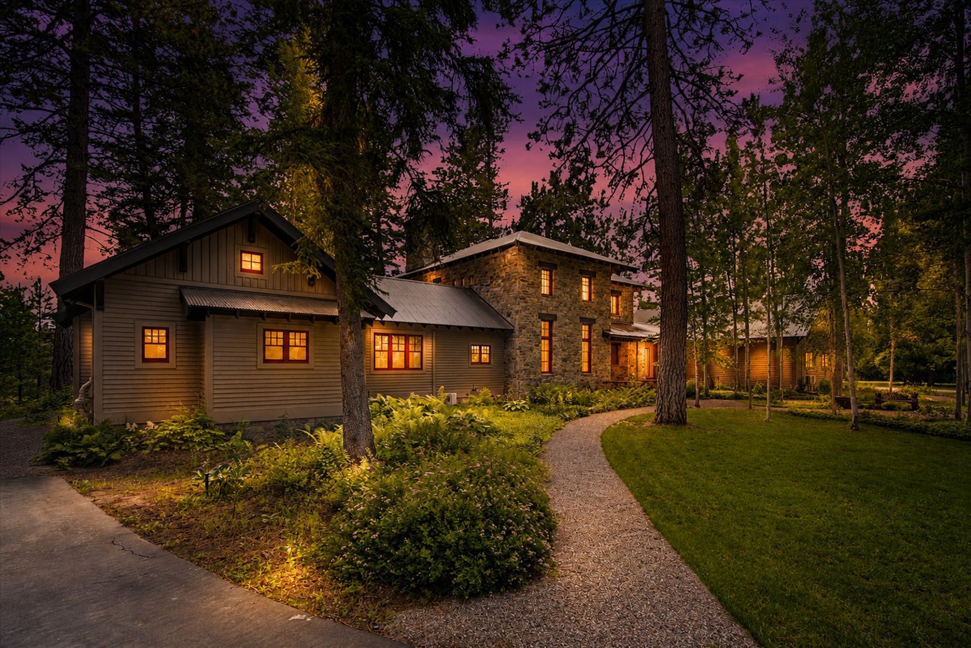 965 Eastman Drive, Bigfork, MT 59911 Beautifully illuminated stone accents and welcoming pathways at dusk