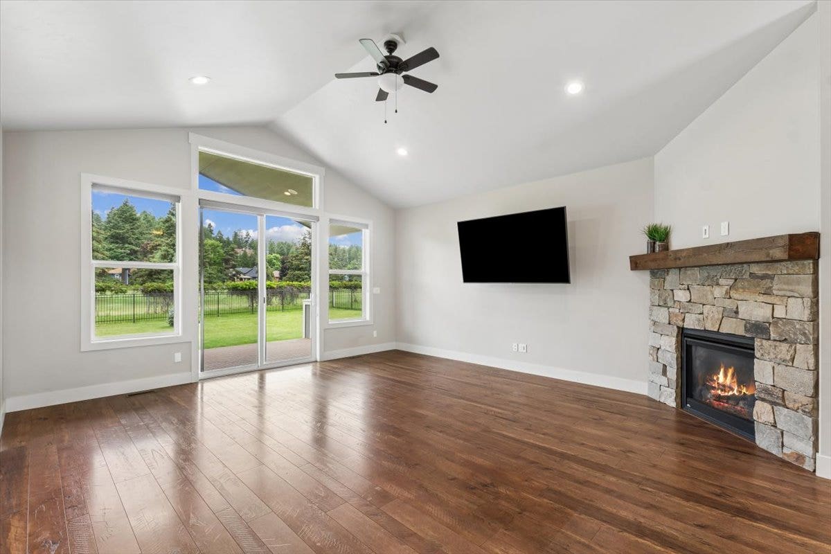 615 Mill Pond Place, Bigfork, MT 59911 Living room with door to patio and gas fireplace