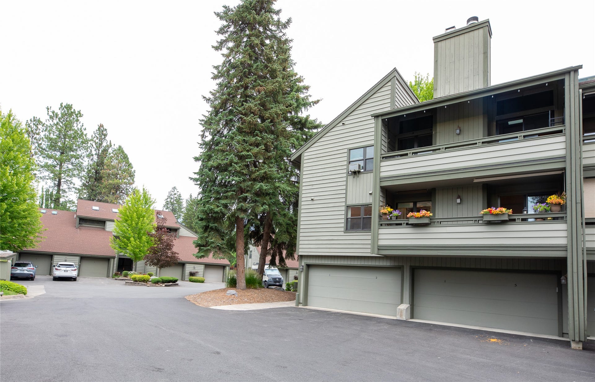 270 Bridge Street, #2, Bigfork, MT 59911 Condo is above garage with flowers on deck