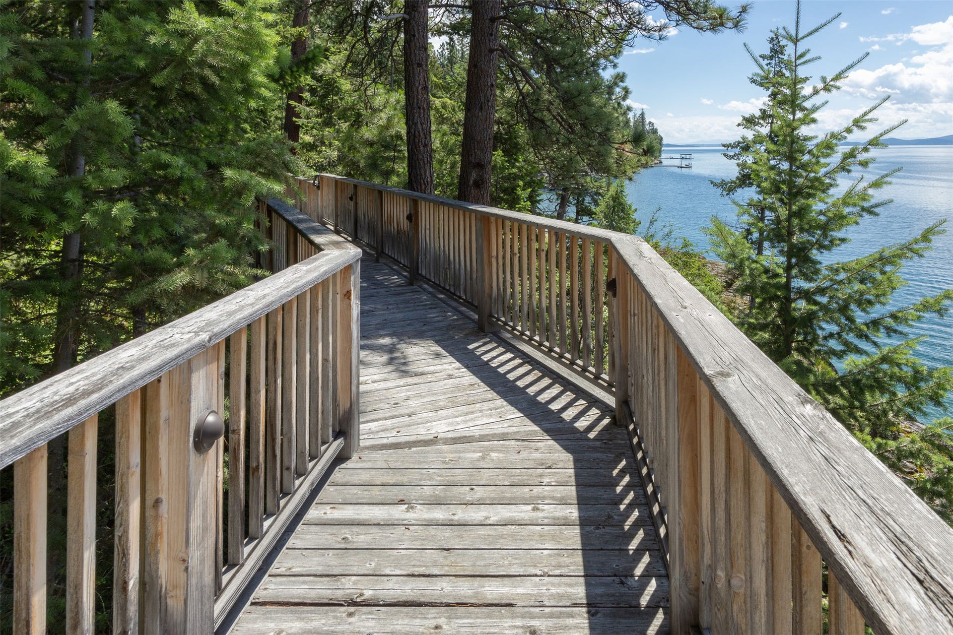 Solid decks and walkways lead to the waterfront below the home.