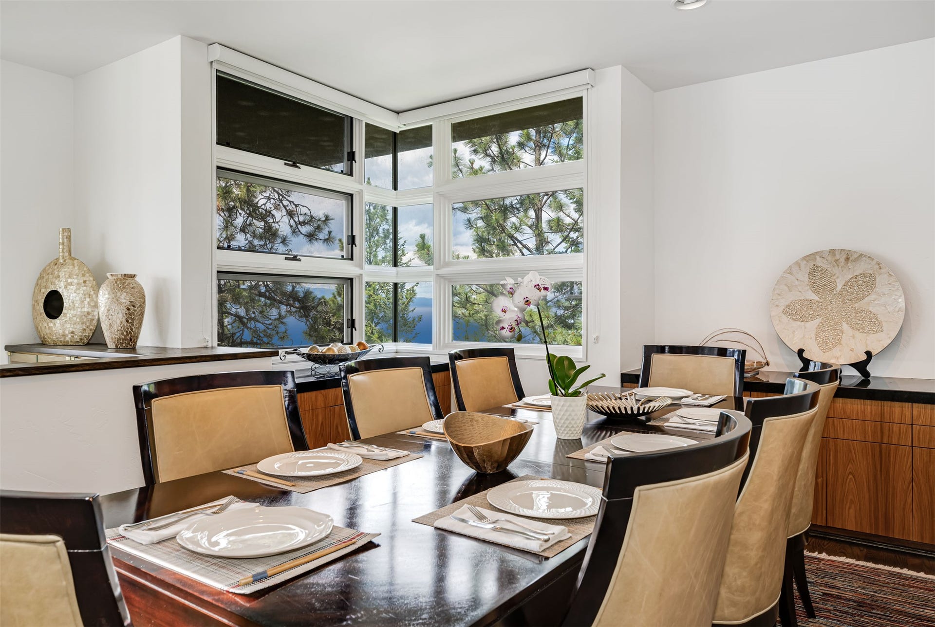 Dining area with expansive window wall, featuring multiple casement windows and built-in cabinetry.