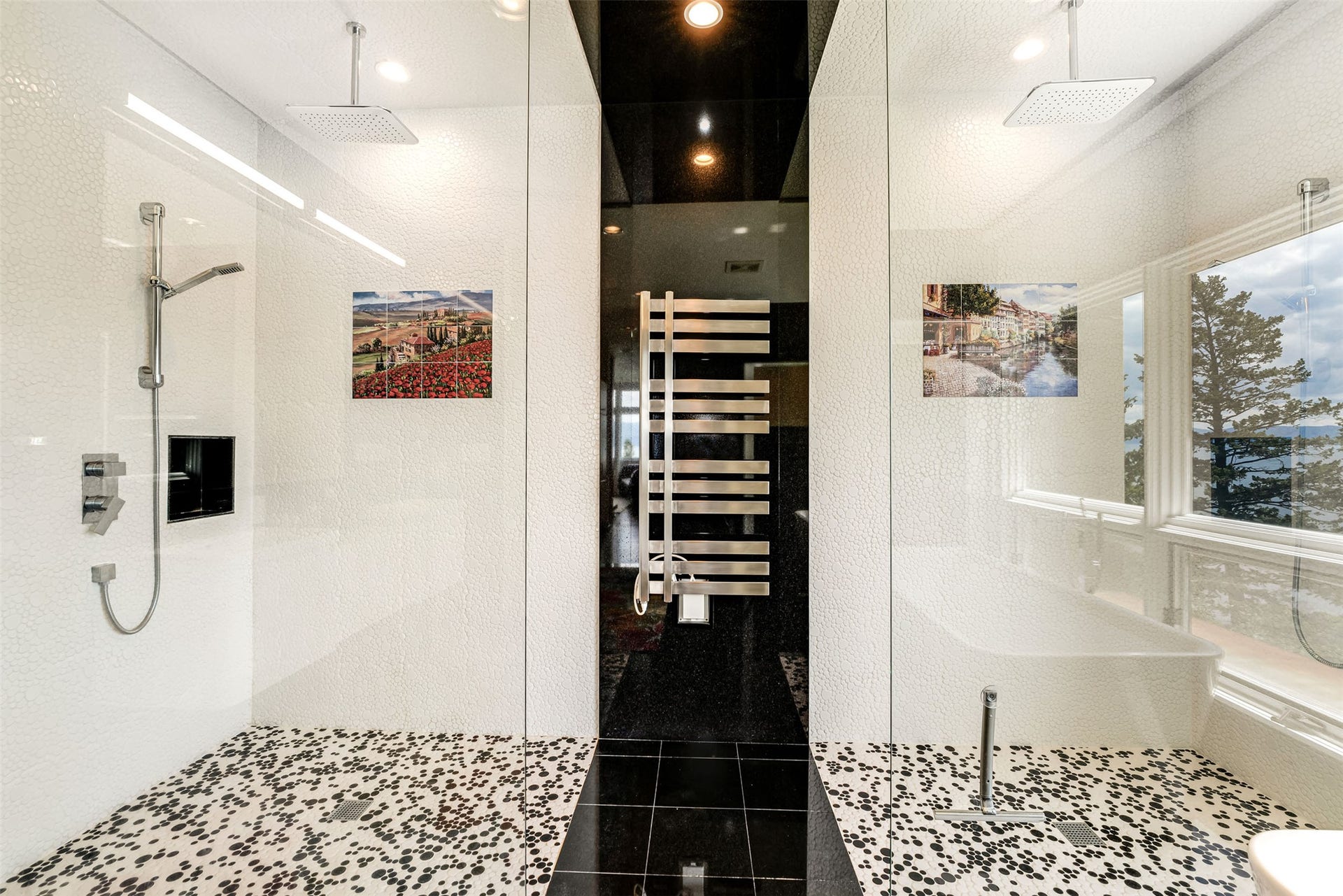 Spa-inspired bathroom featuring a dual walk-in shower with glass enclosures, rain shower heads, and pebble-style flooring
