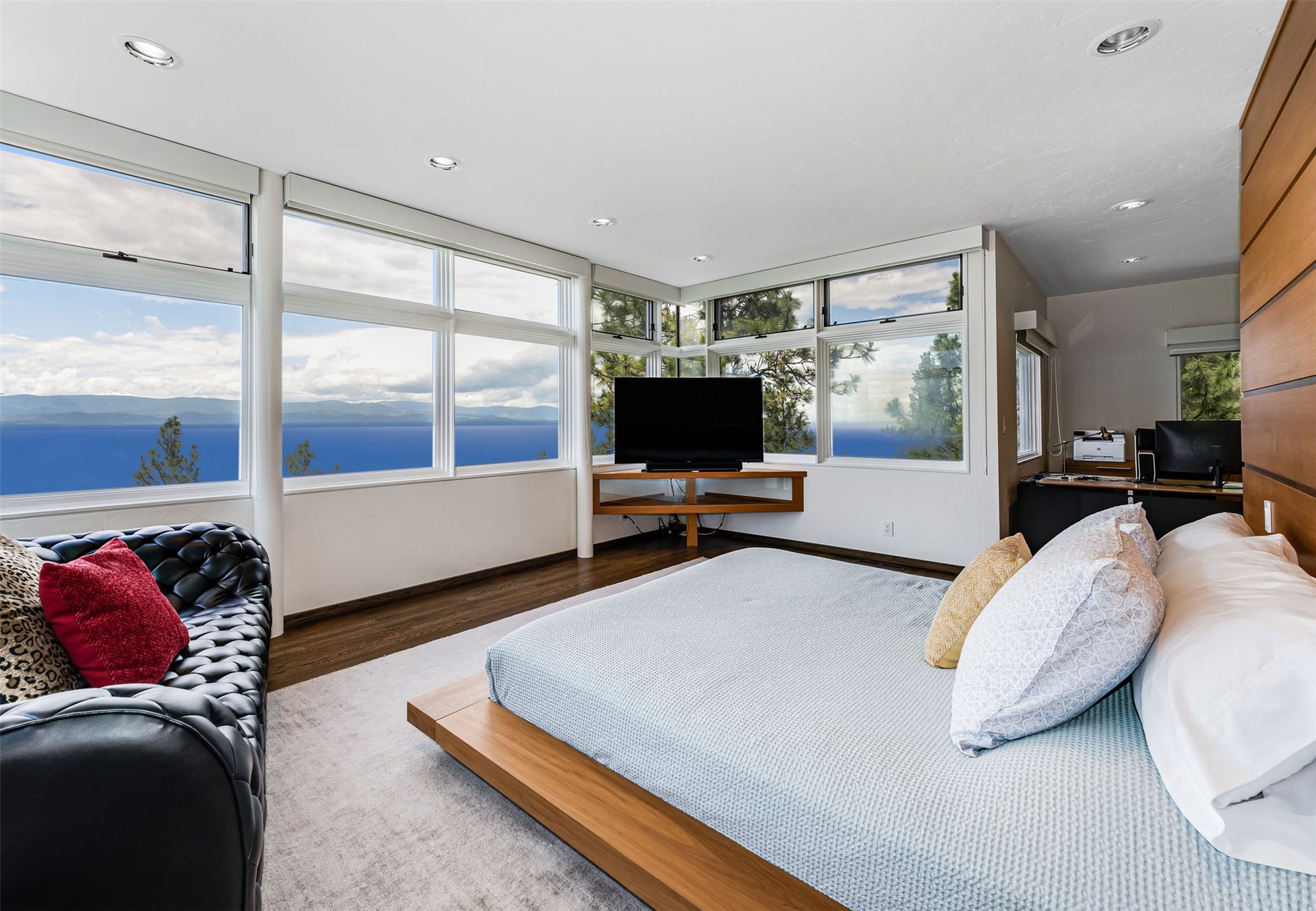 Expansive windows overlooking in a dreamscape of endless sky, mountains and water