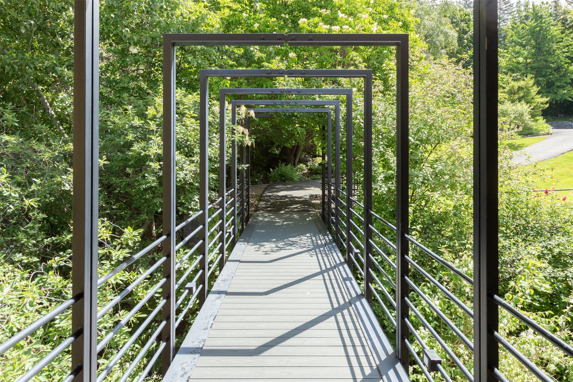 Steel bridge walkway  from the driveway to front door of the home.