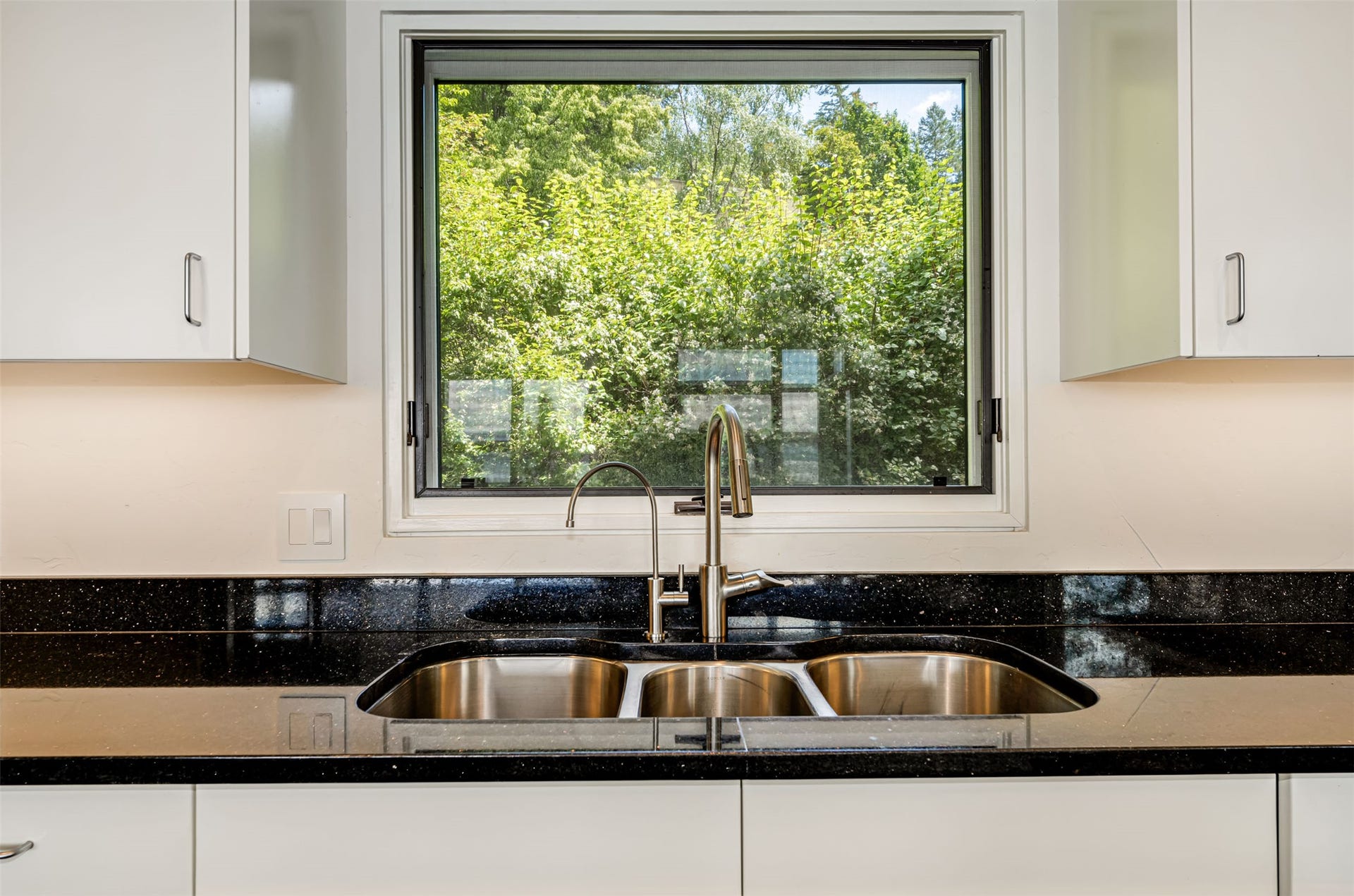 A multi sink stainless basin and high-end faucet accessorize the wonderful cook's kitchen.
