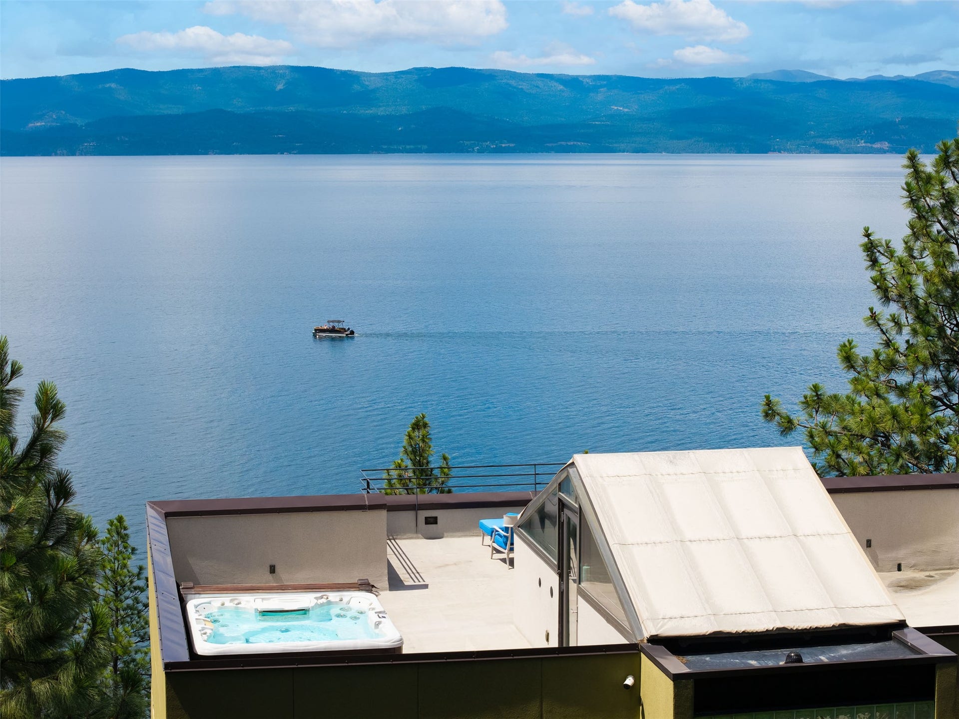 View from the 'crows nest' rooftop terrace featuring an integrated hot tub and expansive water body backdrop