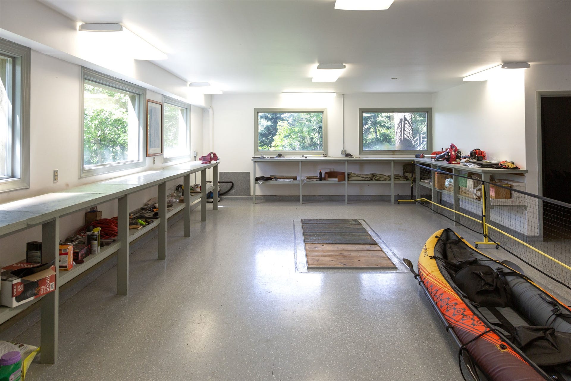 A spacious shop within the 2 stall garage encourage craft or work projects with benches and power on 3 sides. A large storage room provides neat storage for tools and materials.