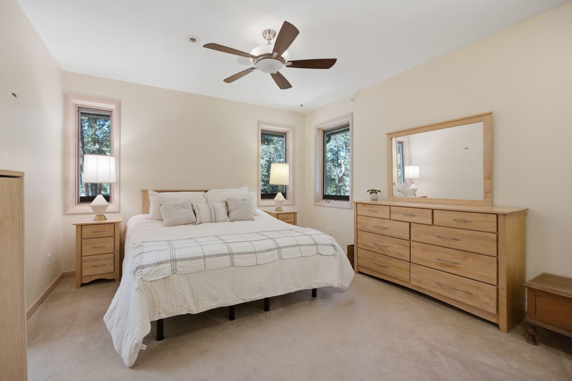 The spacious primary suite offers a peaceful retreat with large windows, abundant natural light, and a generous layout designed for comfort and relaxation.