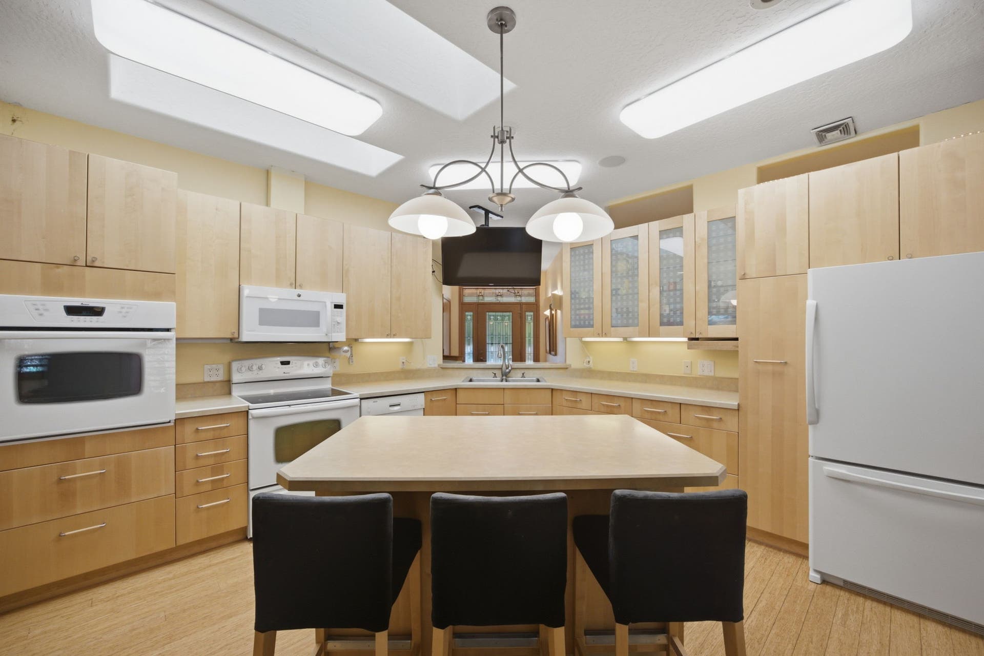 Thoughtfully designed with abundant cabinetry, generous counter space, and a large center island, the kitchen offers both everyday functionality and room to entertain.