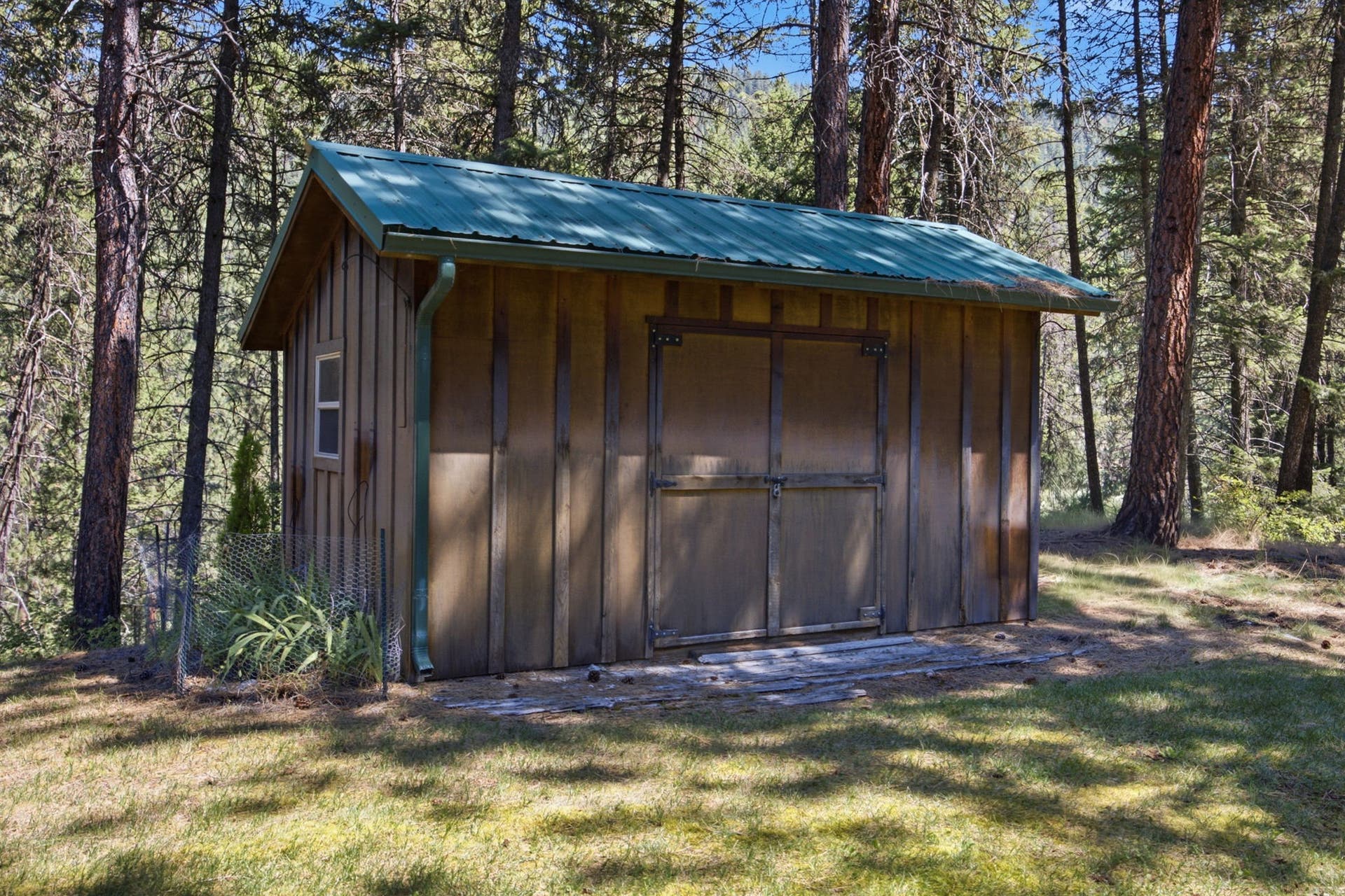 A charming storage shed provides convenient space for gardening tools, outdoor equipment, or seasonal storage, complementing the property's generous outdoor living areas.