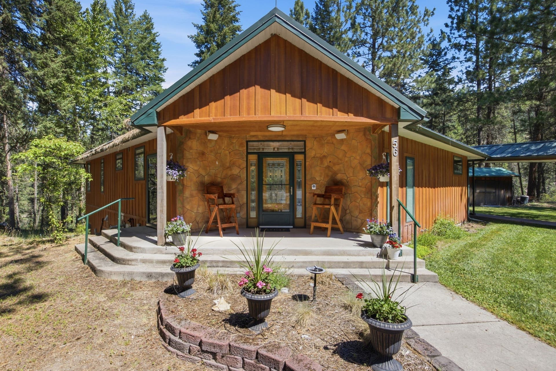 A classic front elevation highlights the home's balanced design, abundant natural light, and inviting entrance. Set on over two acres, the property offers generous outdoor space while maintaining a comfortable, approachable feel.