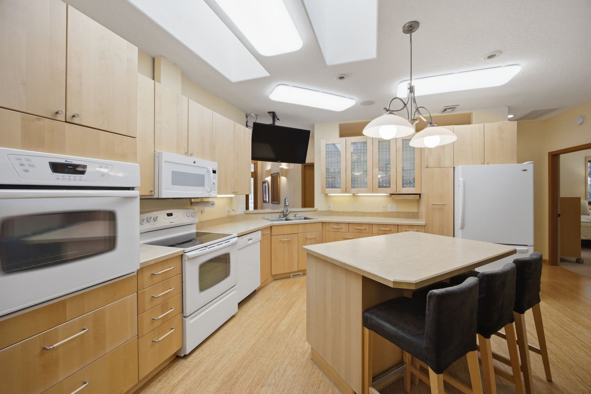 The open-concept kitchen serves as the centerpiece of the home, offering excellent sightlines into the dining and living areas while maintaining a bright, airy feel throughout.