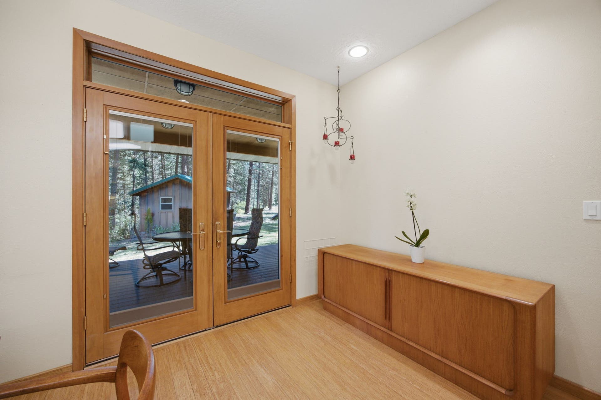 French doors open directly from the dining area to one of the home's outdoor living spaces, creating an easy transition for indoor-outdoor dining and entertaining.