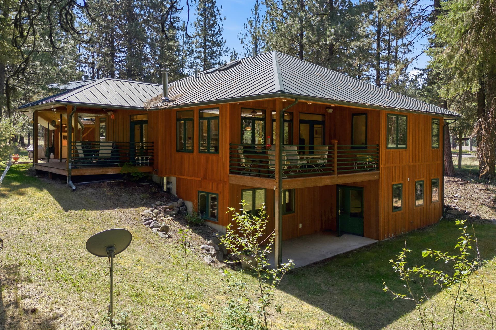 The rear elevation highlights the home's generous outdoor living areas and walkout lower level, offering exceptional space for gathering, entertaining, and enjoying the surrounding landscape.