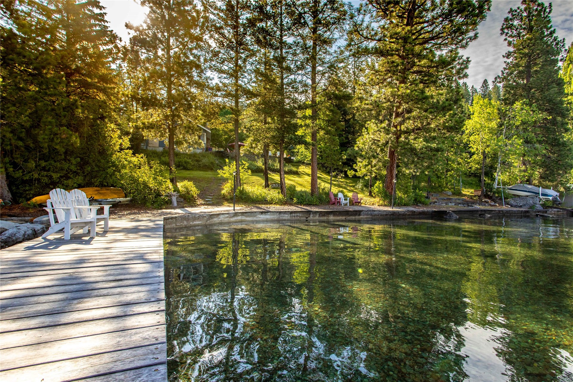 338 Flathead Lodge Road, Bigfork, MT 59911 Filtered morning light on the dock.