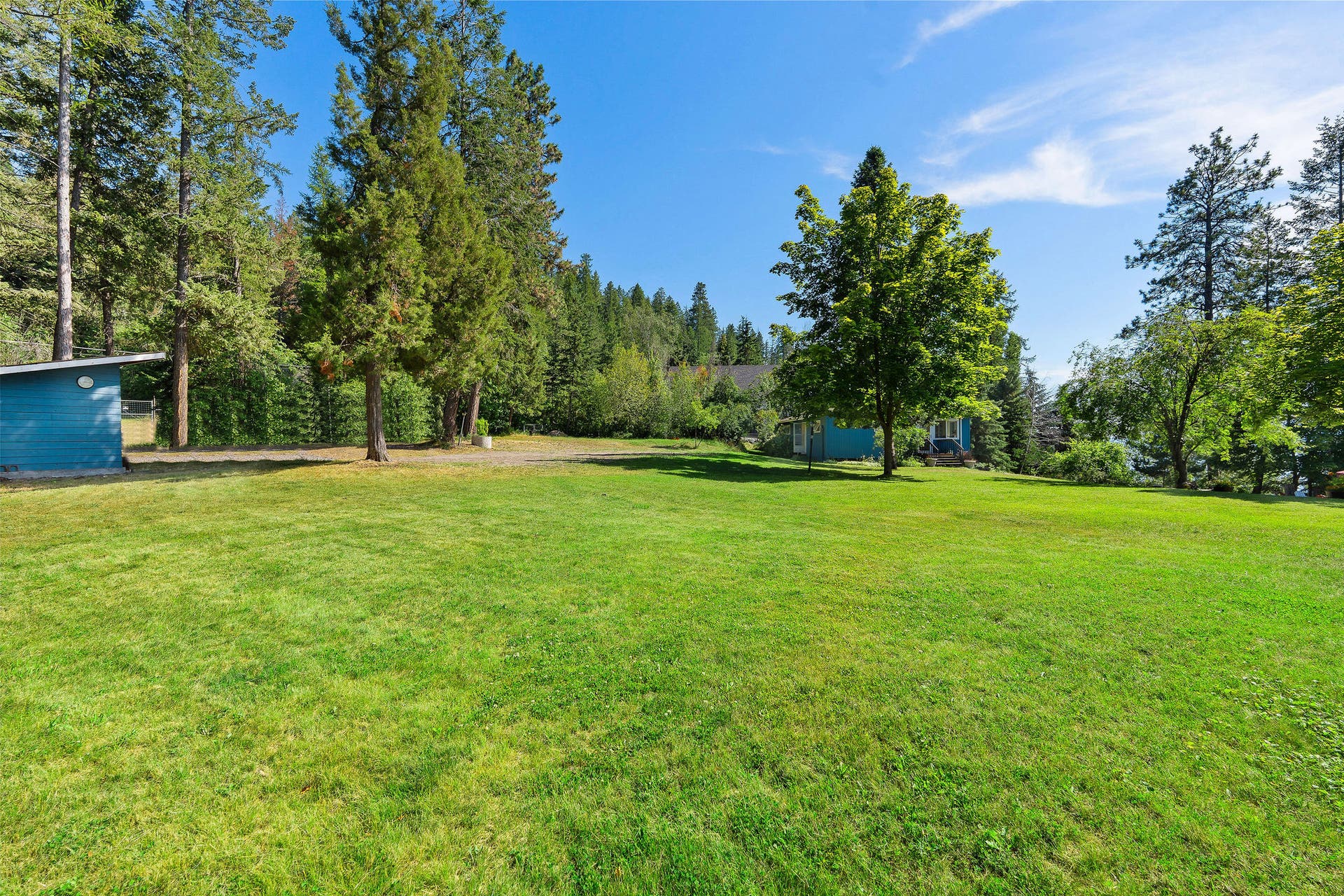 338 Flathead Lodge Road, Bigfork, MT 59911 Grassy area around cabin and bunkhouse.