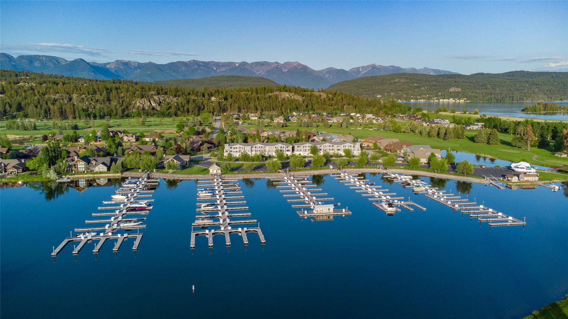 C12 Eagle Bend Yacht Harbor, Bigfork, MT 59911 Drone / aerial view featuring a water and mountain view and a wooded view