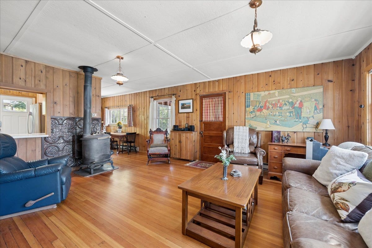 332 Flathead Lodge Road, Bigfork, MT 59911 Living room with wood floors and antique wood stove