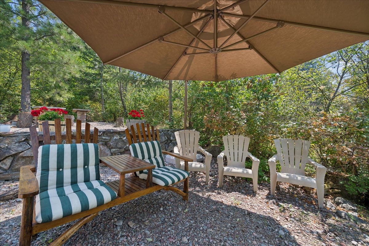332 Flathead Lodge Road, Bigfork, MT 59911 Outdoor graveled patio area outside the cabin