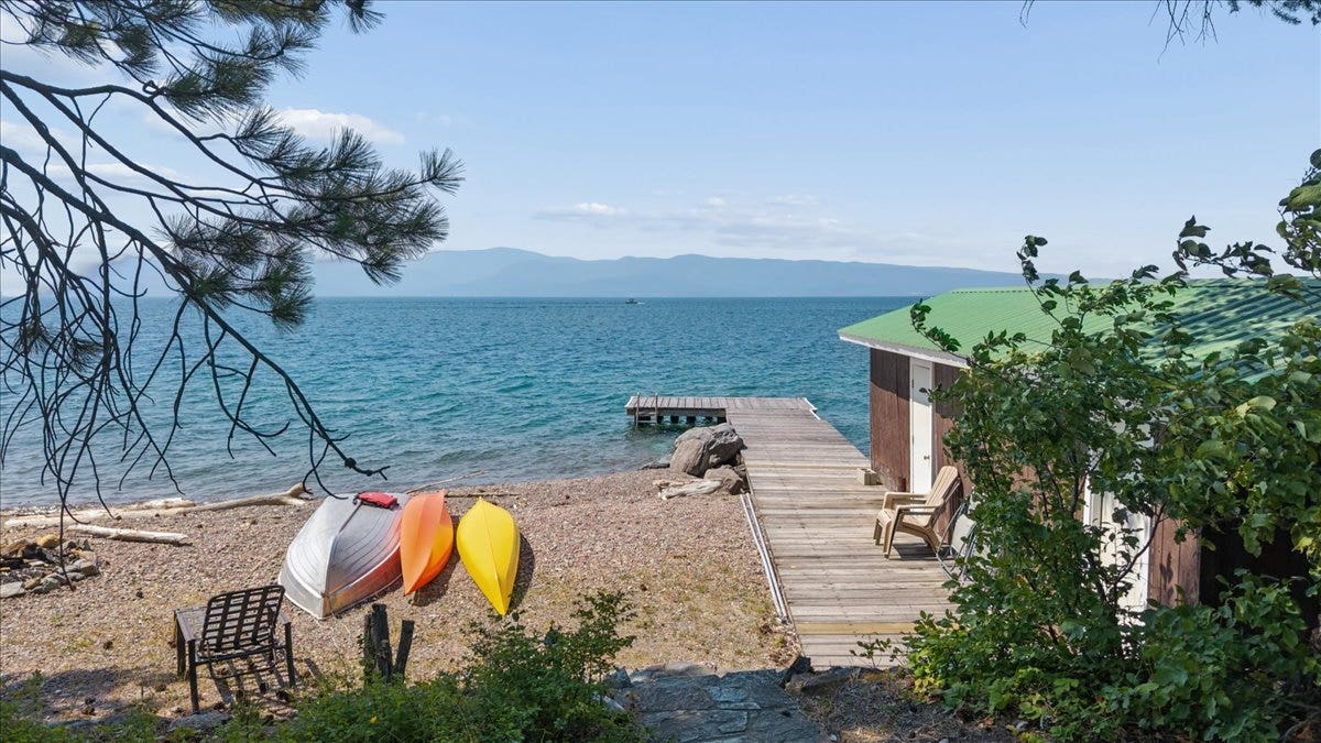 332 Flathead Lodge Road, Bigfork, MT 59911 View of Flathead Lake and beach with dock
