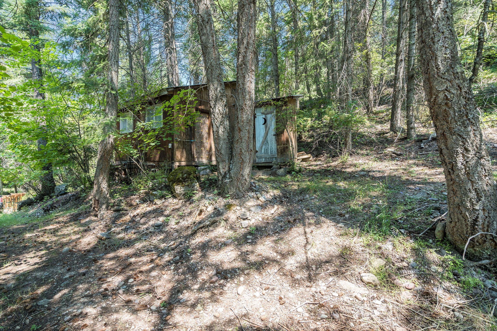 244 Bench Drive, Kalispell, MT 59901 Rustic outbuildings including a historic chicken coop and a fun piece of local historythe classic double outhouse adding true retro Montana character to the property.