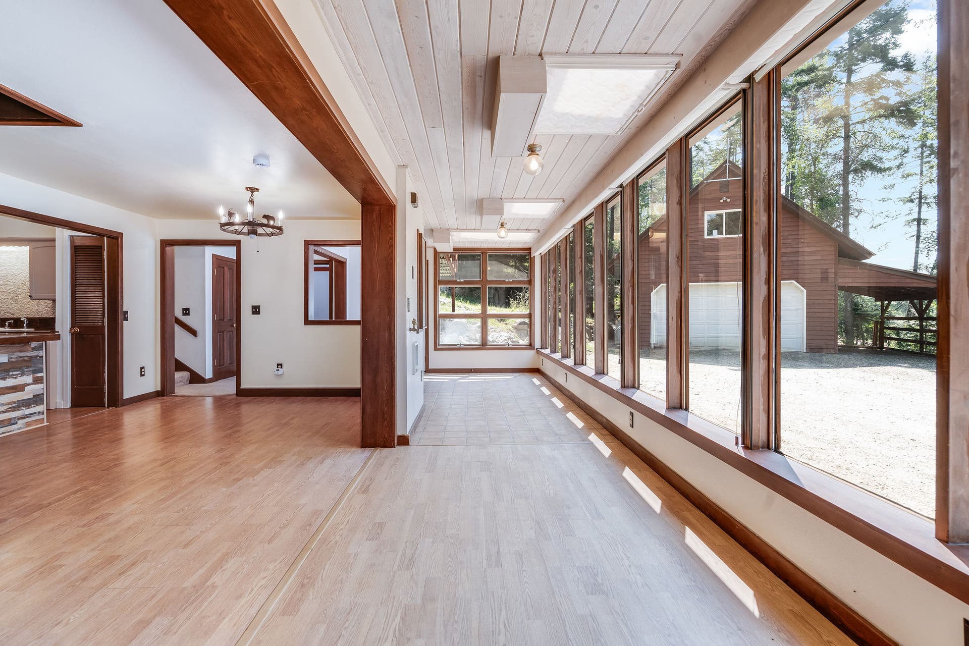 244 Bench Drive, Kalispell, MT 59901 Kalispell MT home with sunroom entry, floor-to-ceiling windows, and natural light. Sun-drenched sunroom entry wrapped in full windowsthe ultimate light-filled mudroom or morning coffee nook.