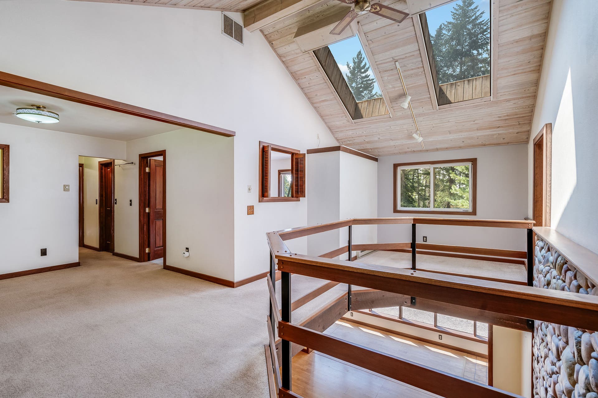 244 Bench Drive, Kalispell, MT 59901 Upper level open loft living space overlooking the main floor rock surround wood stove below.