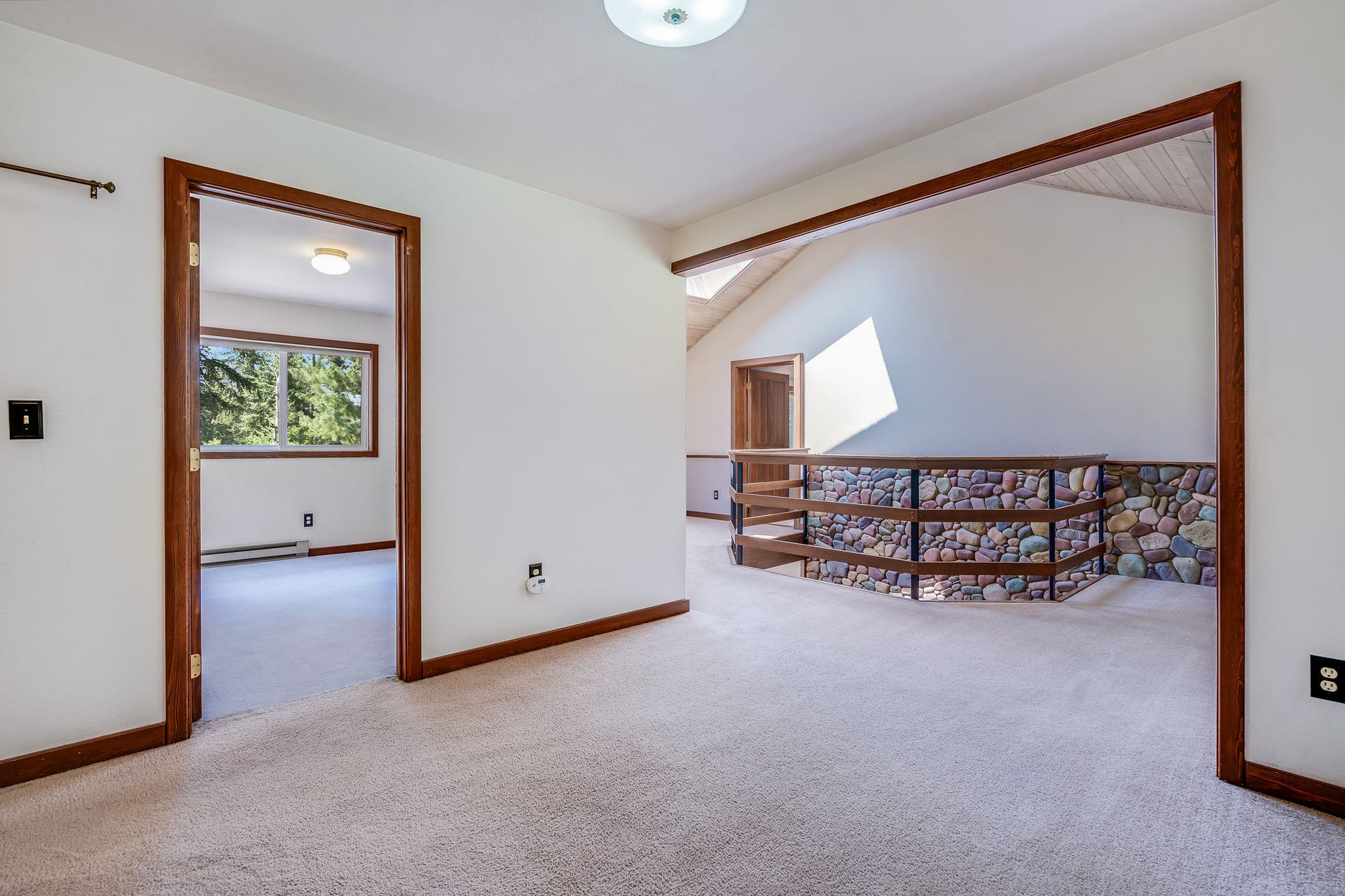 244 Bench Drive, Kalispell, MT 59901 Upper level open loft living space overlooking the main floor rock surround wood stove below.