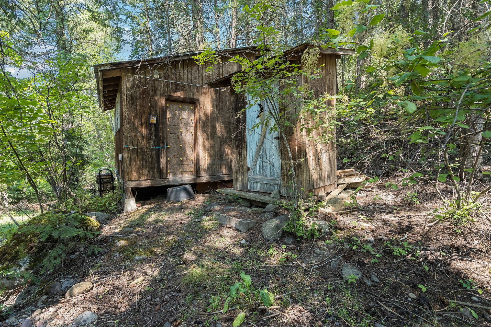 244 Bench Drive, Kalispell, MT 59901 Rustic outbuildings including a historic chicken coop and a fun piece of local historythe classic double outhouse adding true retro Montana character to the property.