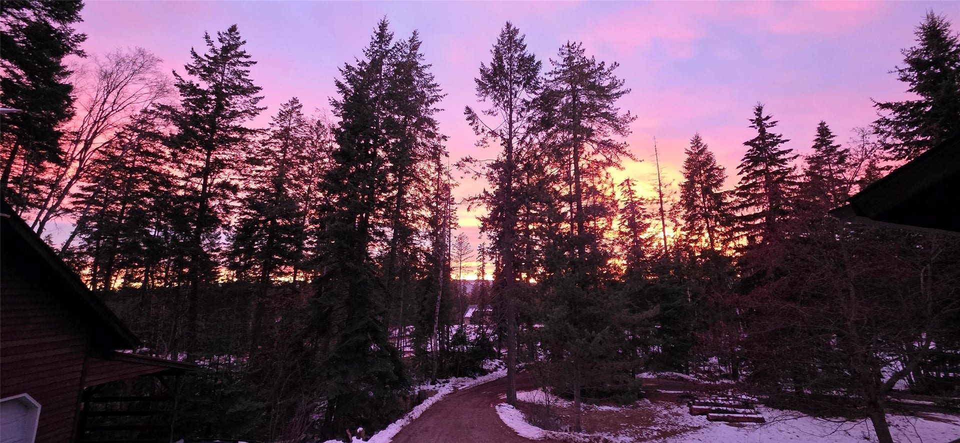 244 Bench Drive, Kalispell, MT 59901 Panoramic evening sunset views over wooded land near Flathead Lake in Kalispell Montana.