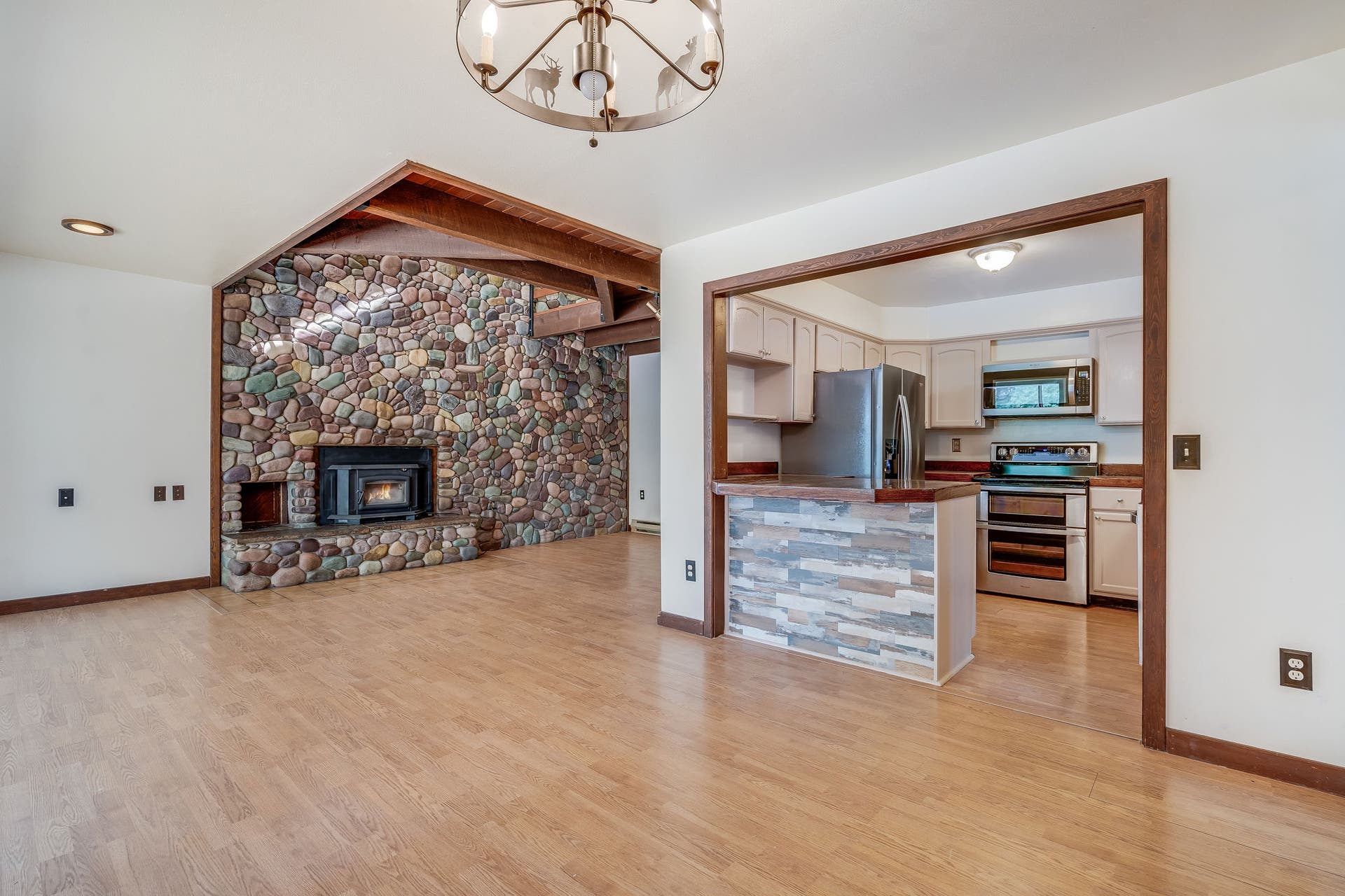 244 Bench Drive, Kalispell, MT 59901 Spacious living room featuring a rock surround wood burning stove in a Kalispell Montana home. Spacious main living area centered around a stunning rock-surround wood-burning stove for cozy Montana evenings.