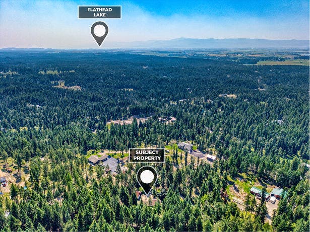 244 Bench Drive, Kalispell, MT 59901 Aerial drone shot of 244 Bench Run home on 3 acres near Flathead Lake and Bigfork MT. Wooded privacy just minutes from Flathead Lake, Bigfork, and world-class hiking in the Jewel Basin.