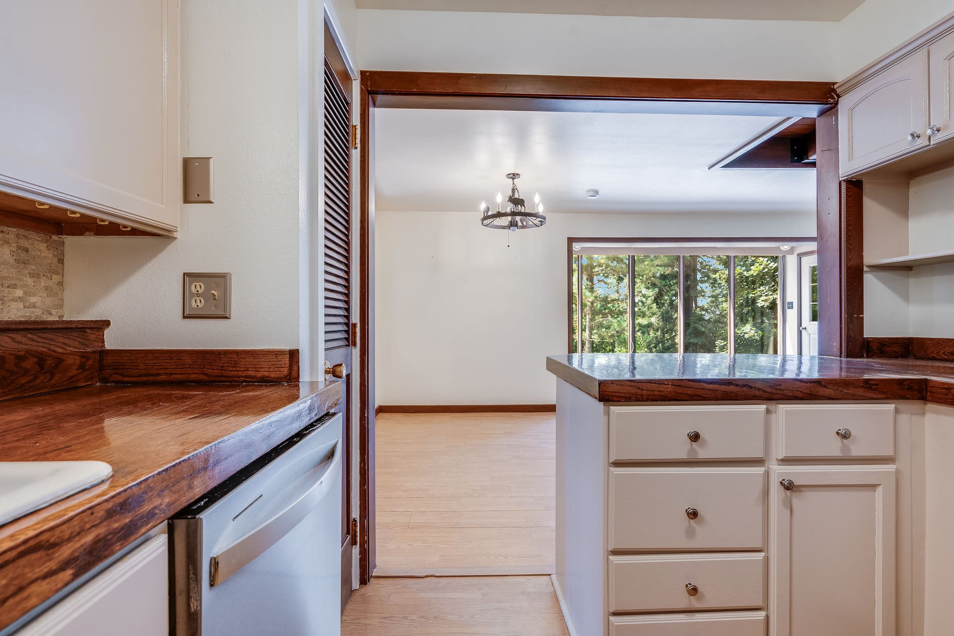 244 Bench Drive, Kalispell, MT 59901 Functional kitchen and dining space featuring solid 1980s build quality and warm wood accents throughout.