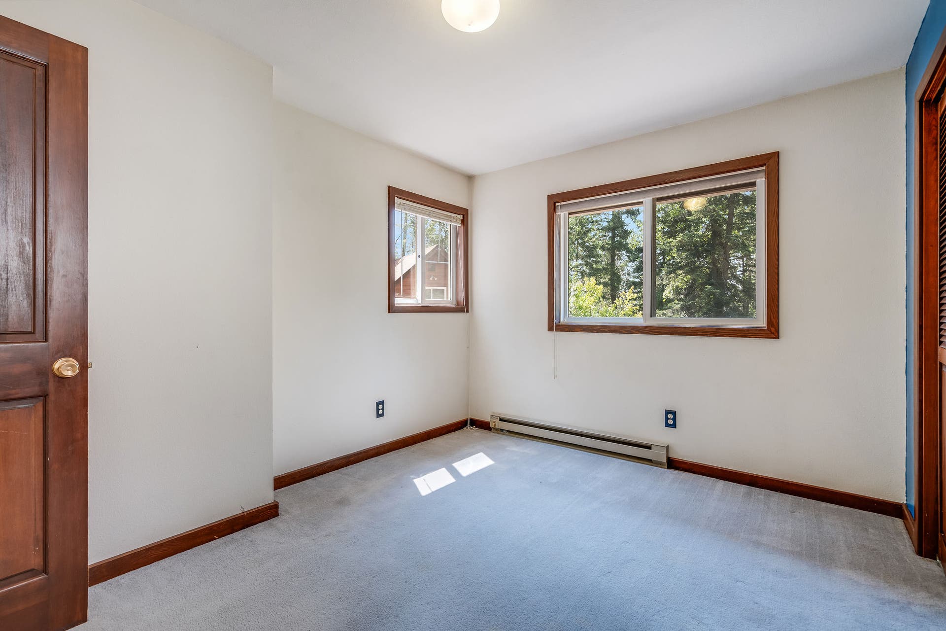 244 Bench Drive, Kalispell, MT 59901 Bright and comfortable guest bedroom offering great natural light and traditional charm.